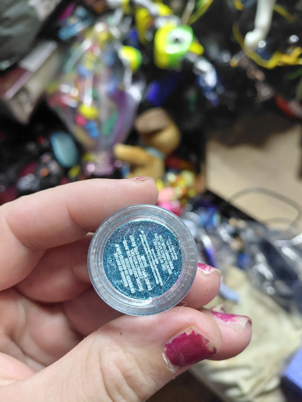 small, round container of blue-toned body glitter featuring Minions on lid .07oz